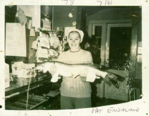 Historic photo of woman holding fish from Otter Tail County lake.