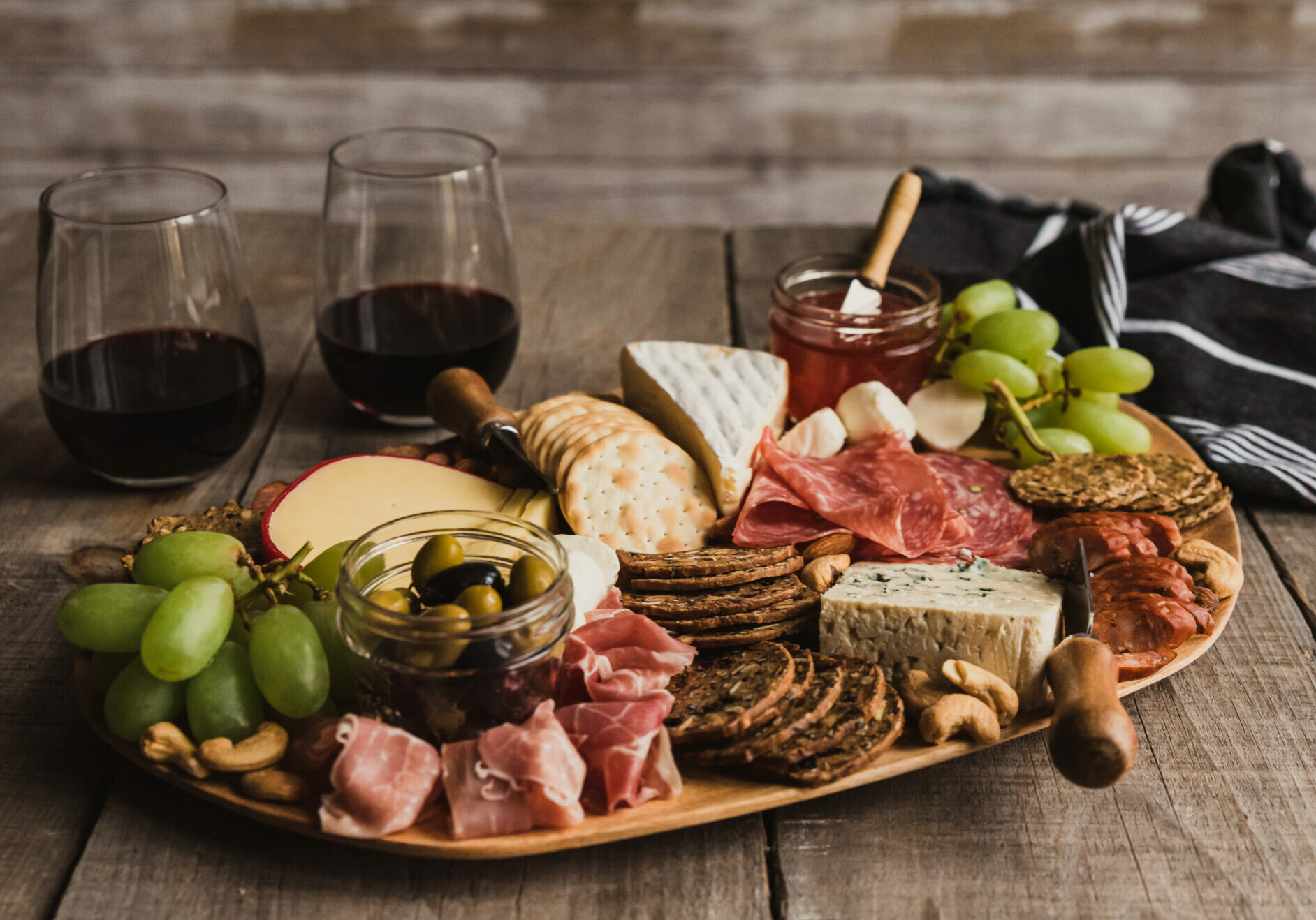 Close up of charcuterie board and glasses of wine on wooden table. in Kingston, ON, Canada